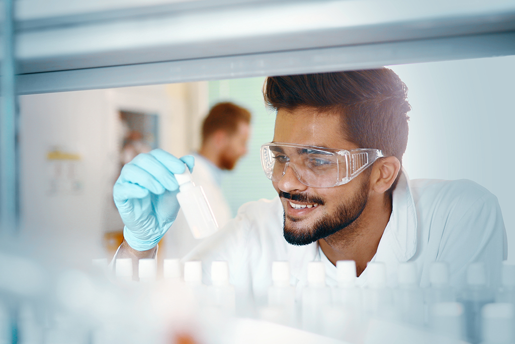 Male chemistry student working in laboratory