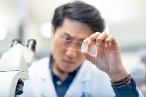 Male chemist analyzing test sample