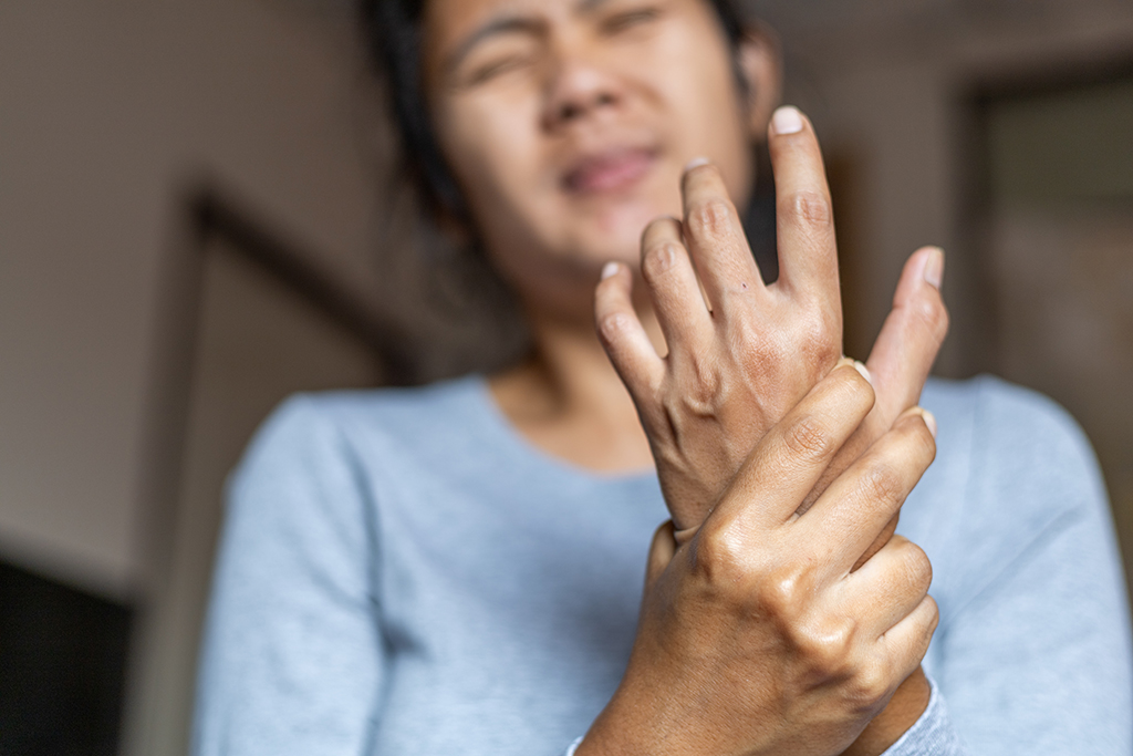 Young women grabbing wrist in pain