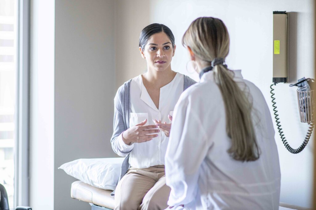 Woman talking with her provider in an exam room