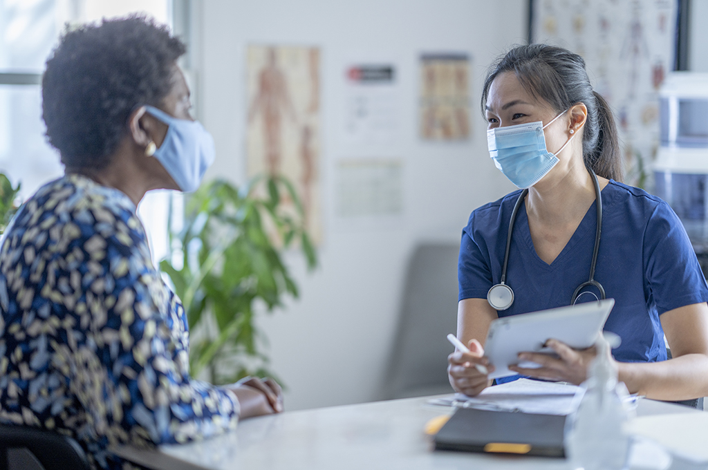 Asian Female doctor meeting patient