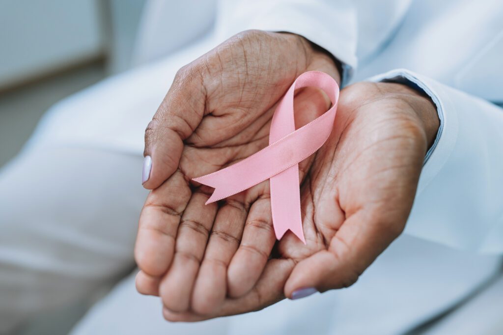 Hands holding pink breast cancer awareness ribbon