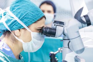 Female surgeon looking through lens of surgery robot