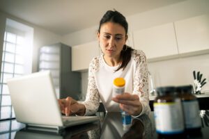 Female files her prescription online through her laptop