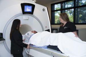 Radiology technicians helping patient in MRI machine