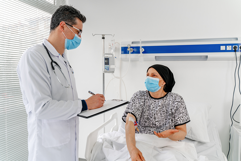 Stressed woman in the hospital talking with her doctor