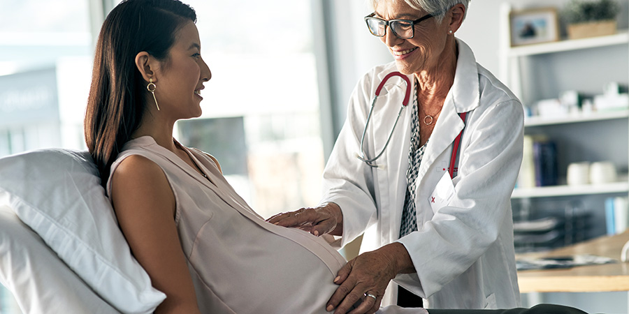 Female doctor caring for a pregnant female patient