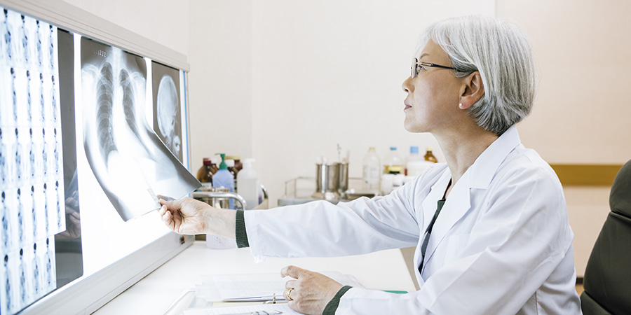 Female doctor looking at chest x ray