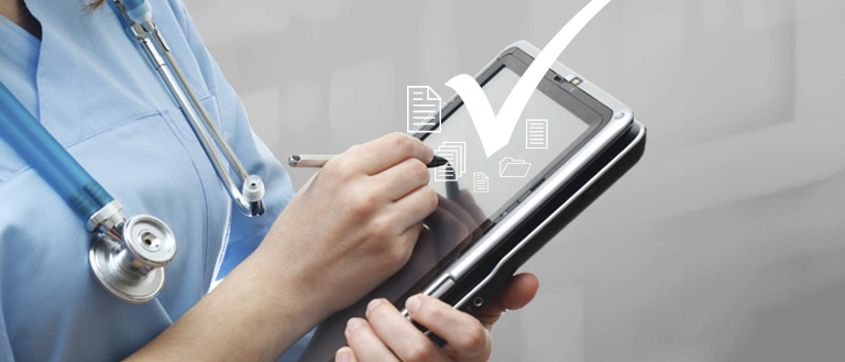 Medical professional checking patient's records on a tablet