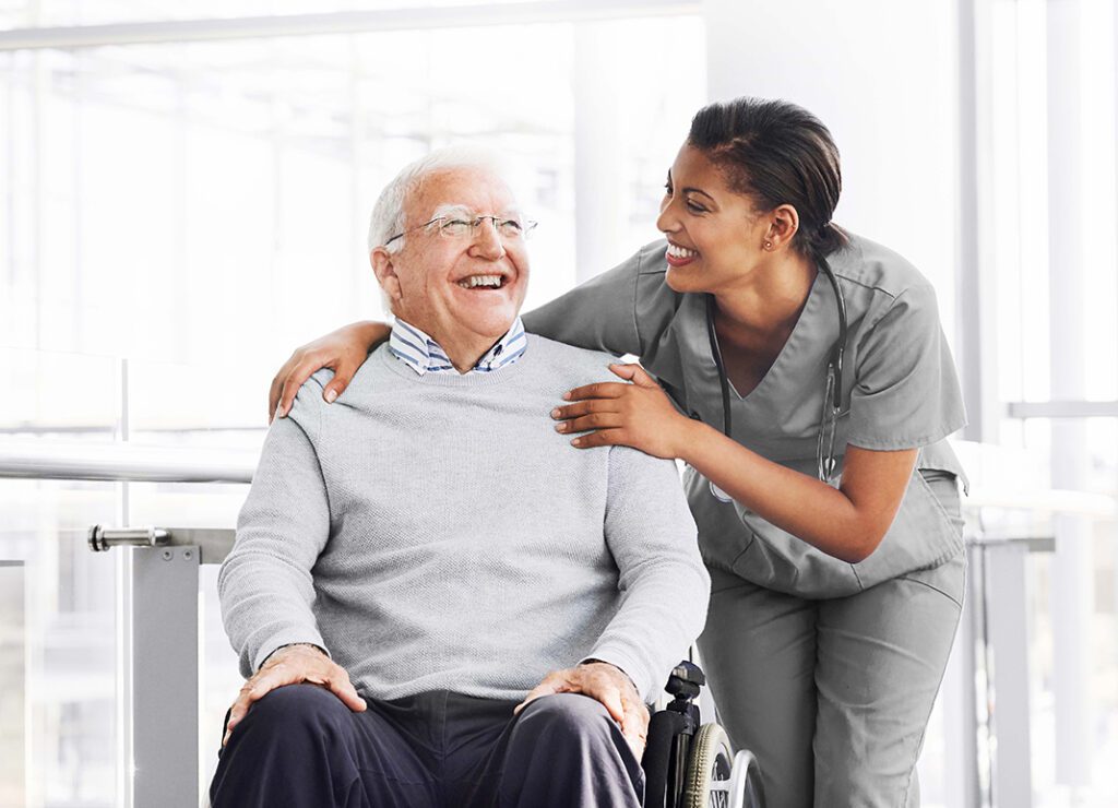 Female medical professional laughing with older male patient