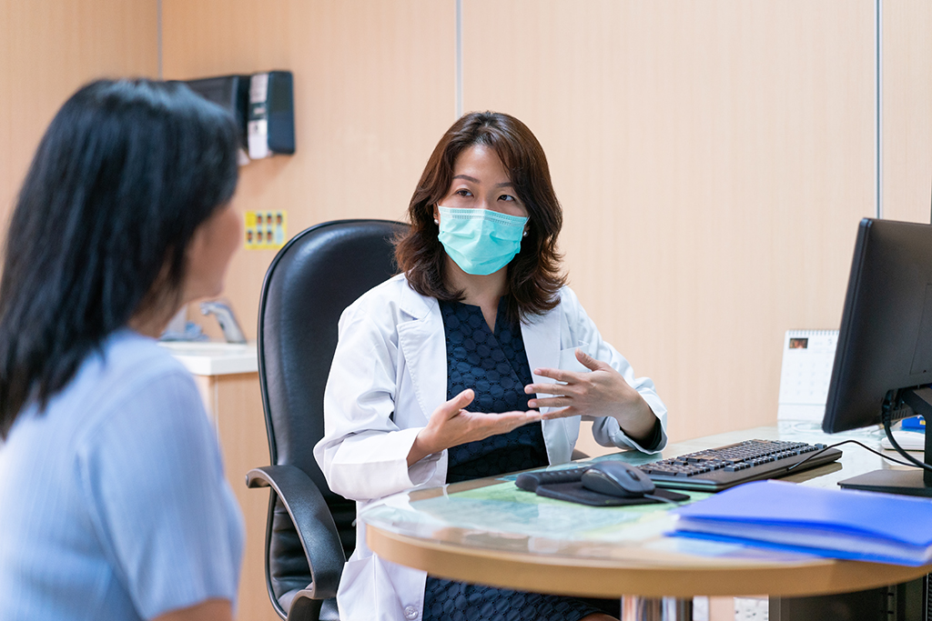 Medical practitioner explaining to patient at office