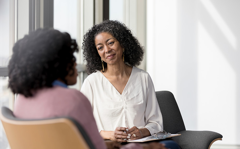 Mature counselor listens to female client