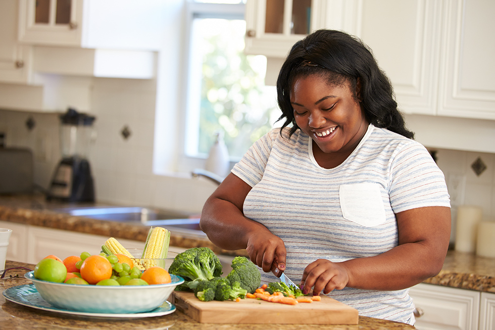 Overweight Woman Preparing Vegetables in Kitchen