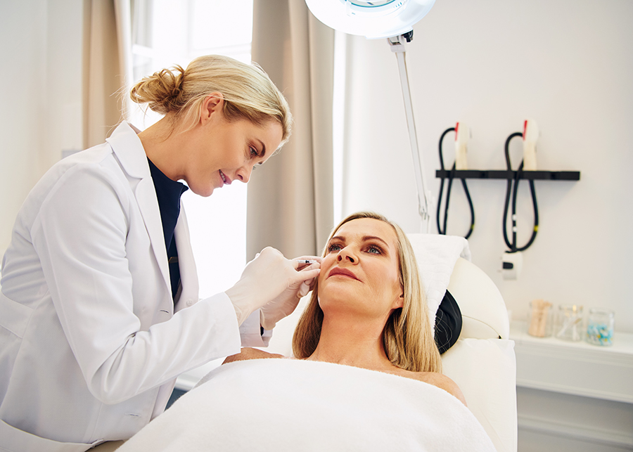 Doctor doing botox injections on a female client's face