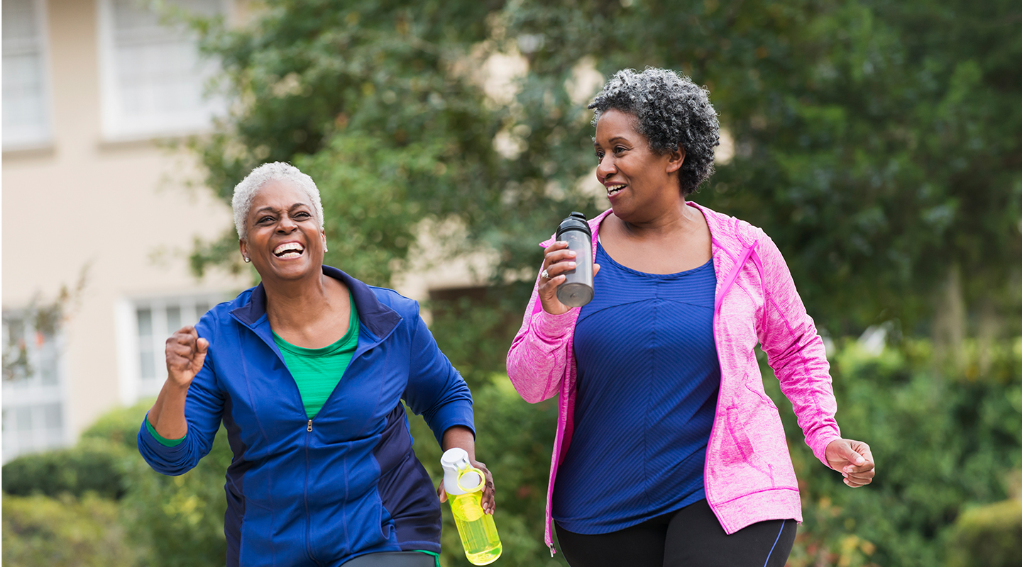 Two black women power walking outside