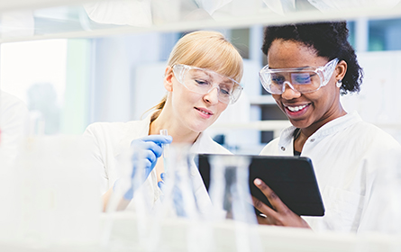 Two female scientists working together in lab