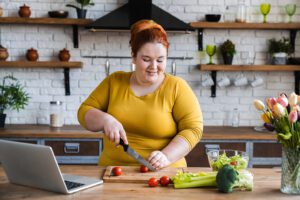 Woman learning to make salad from social media