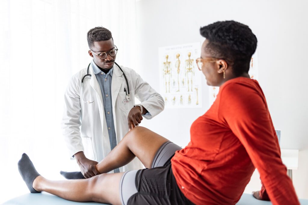 Doctor examining patient's knee