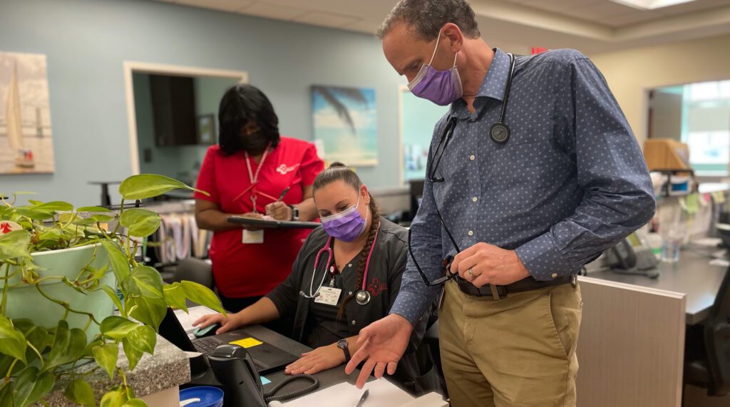 Medical Professionals conversing around a desk