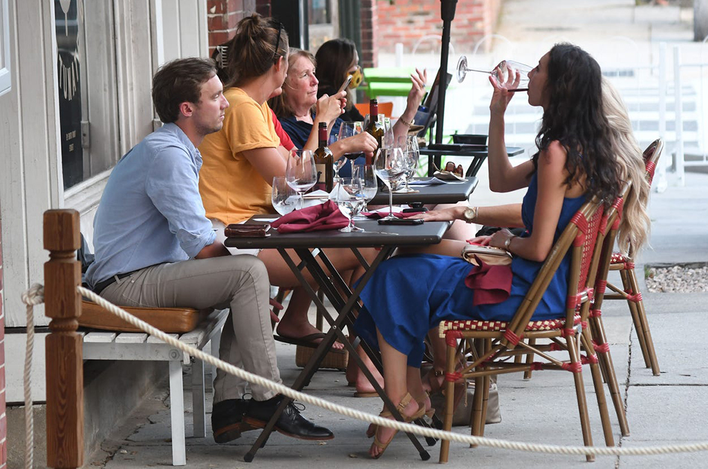 Diverse group eating dinner outside