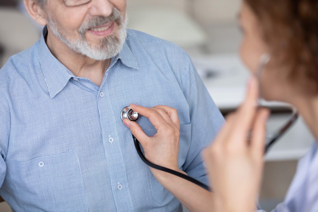 Provider using a stethoscope to listen to a patients heart