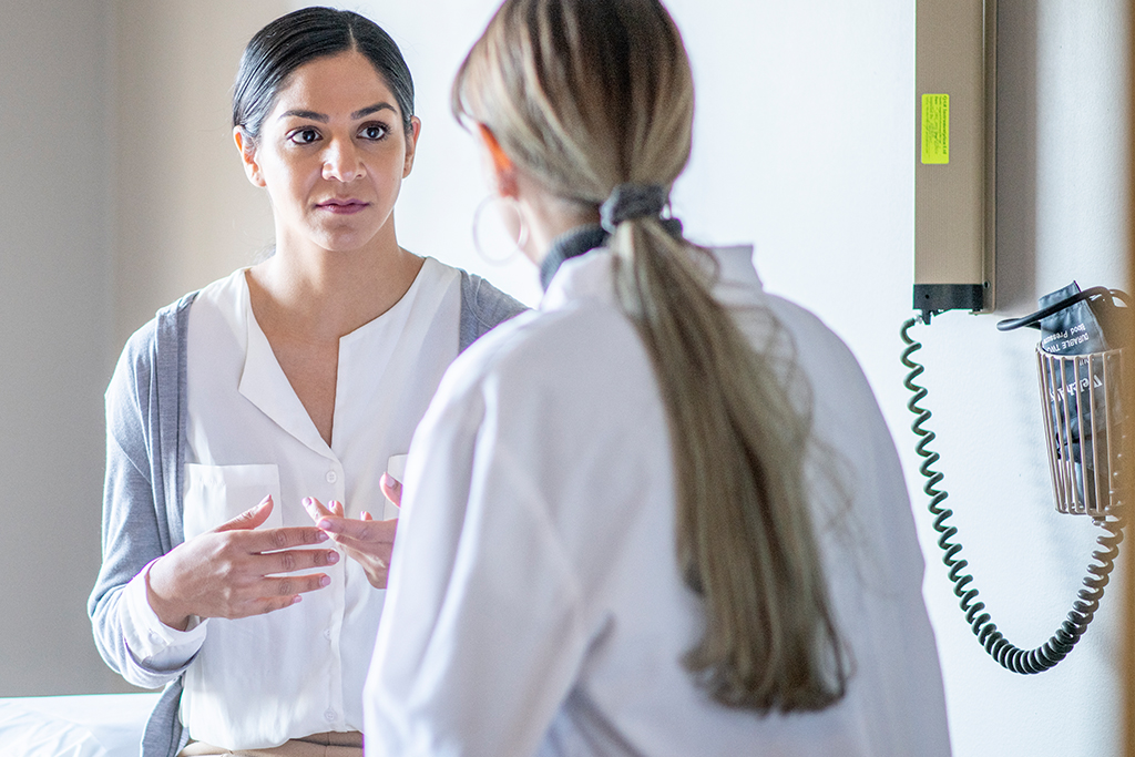 Woman meets with doctor.