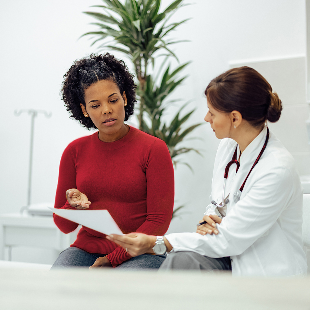 Woman discusses test results with doctor