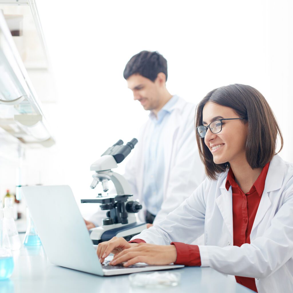 Lab technician looks at her laptop.