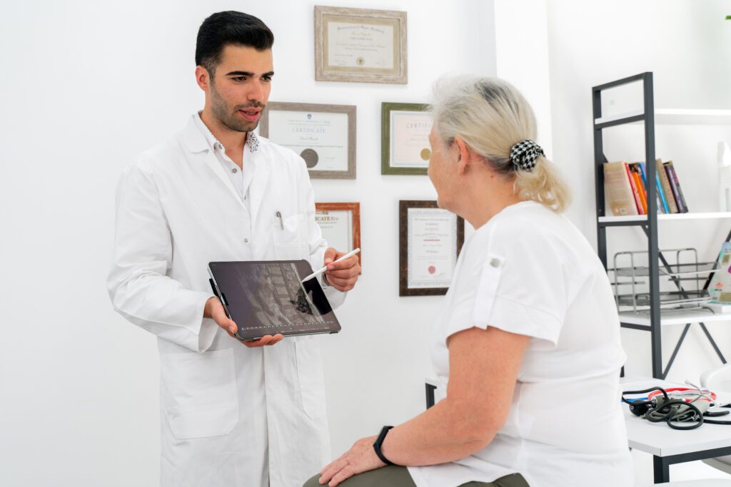 Young doctor shows patient her diagnostic scans