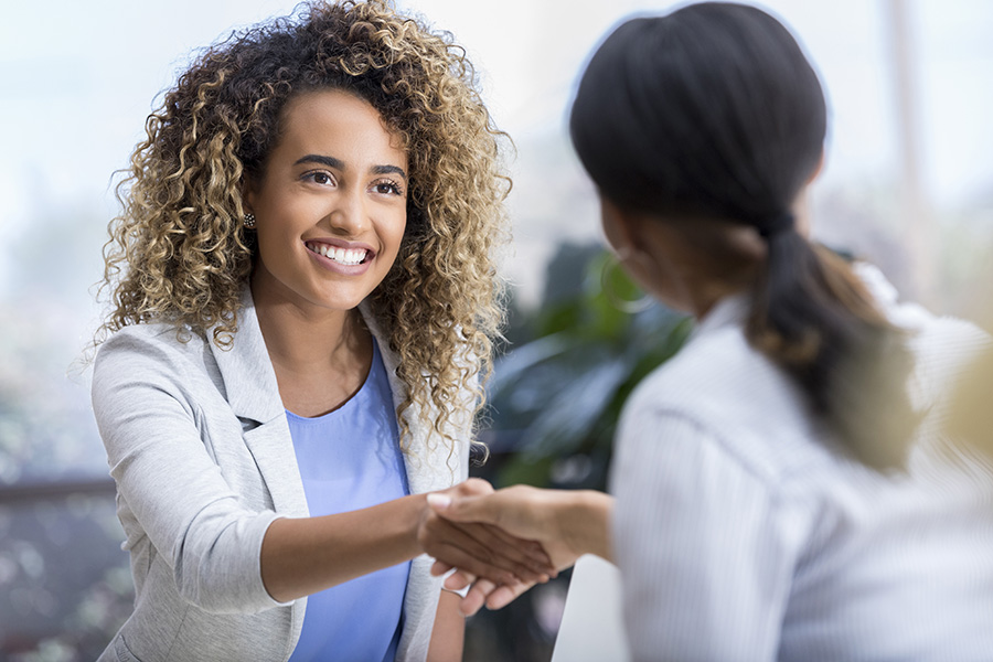 Woman shaking hands with doctor