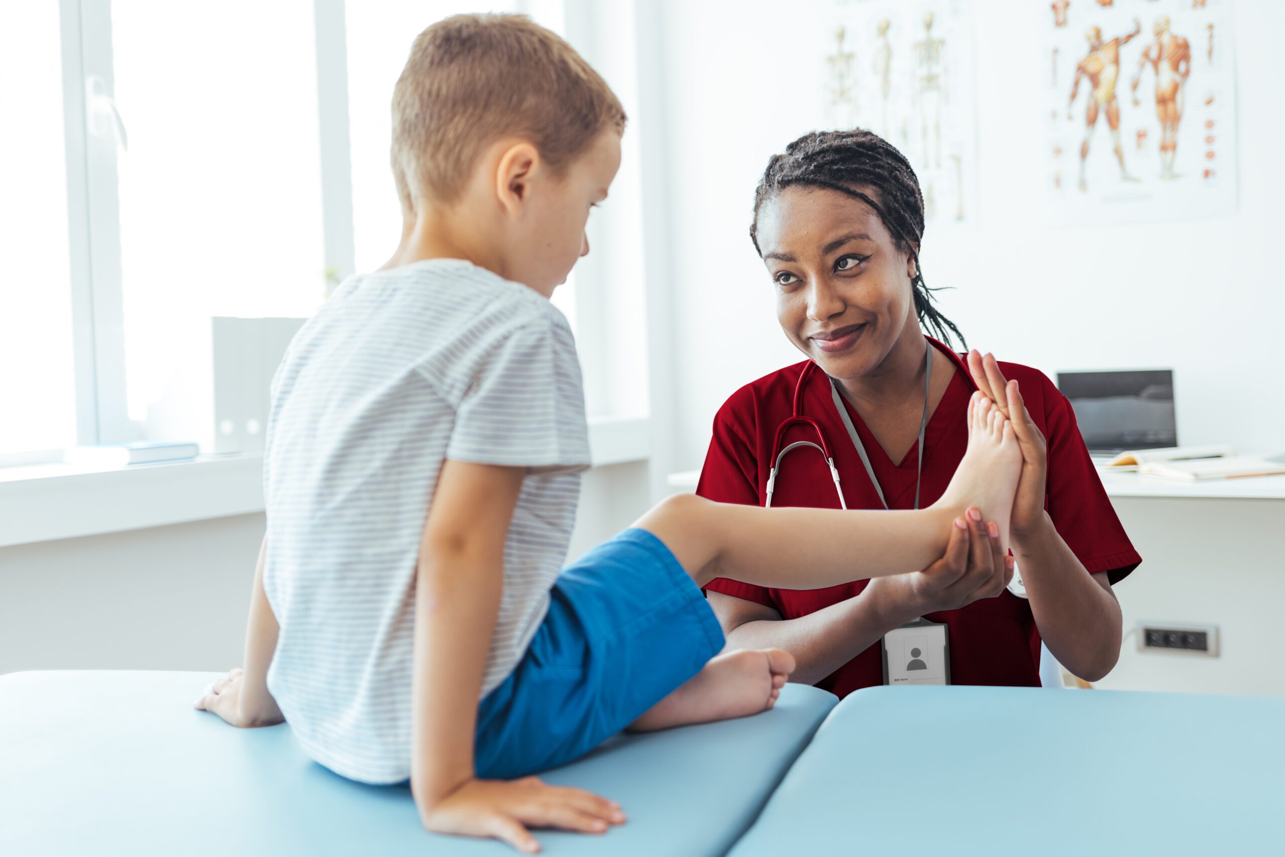 Pediatrician working with a patient with flat feet