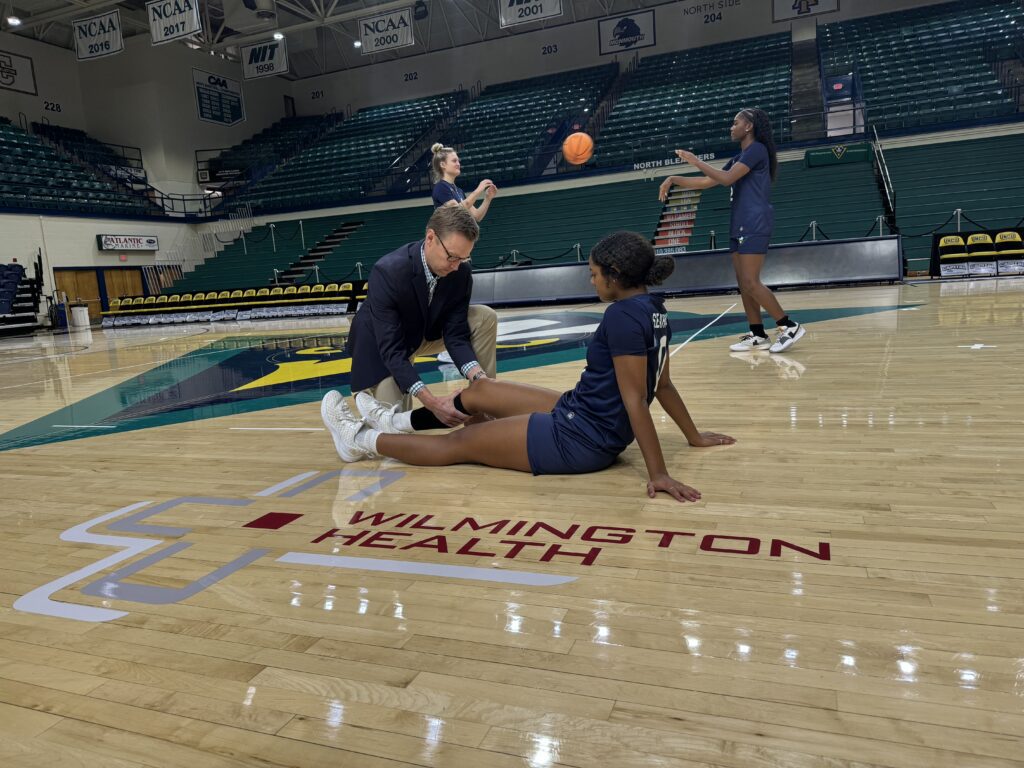Sports medicine physician examines student-athlete at UNCW