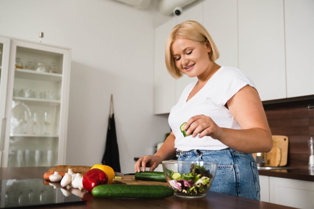 Young woman cooks in her kitchen