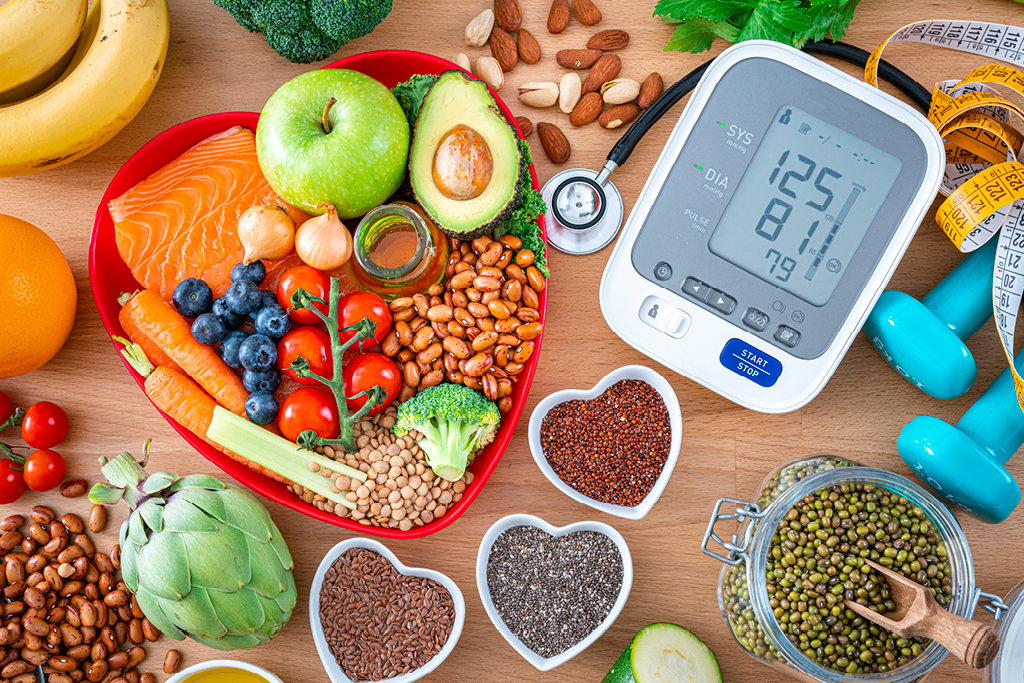 Healthy foods next to a blood pressure monitor