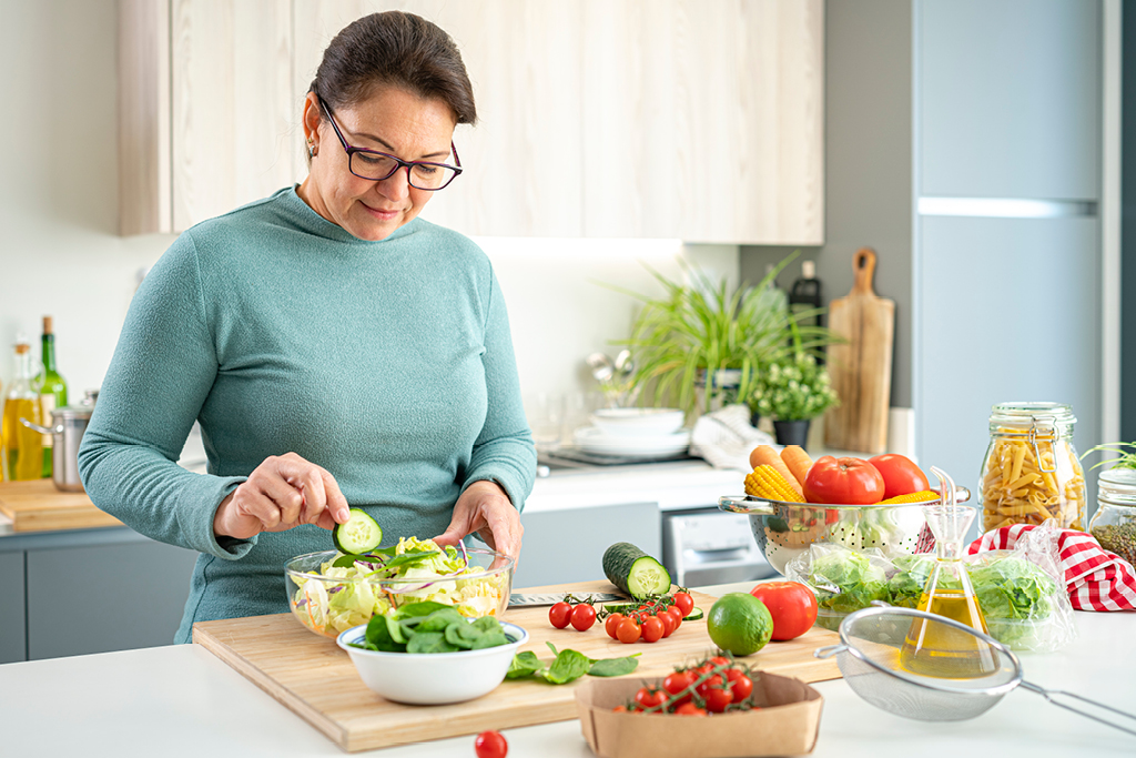 Woman fixing herself a salad