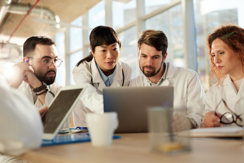 Team of doctors looking at a laptop in hospita