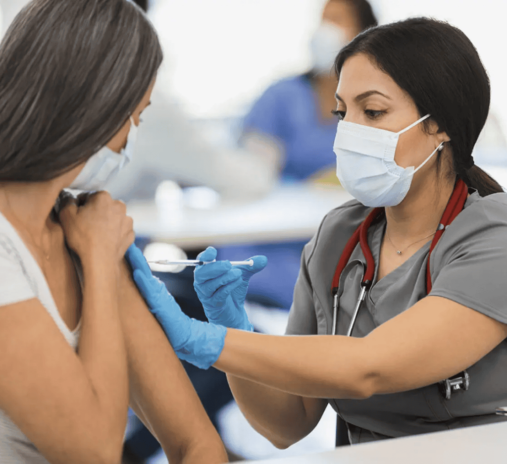 Provider giving a person a flu shot in the arm